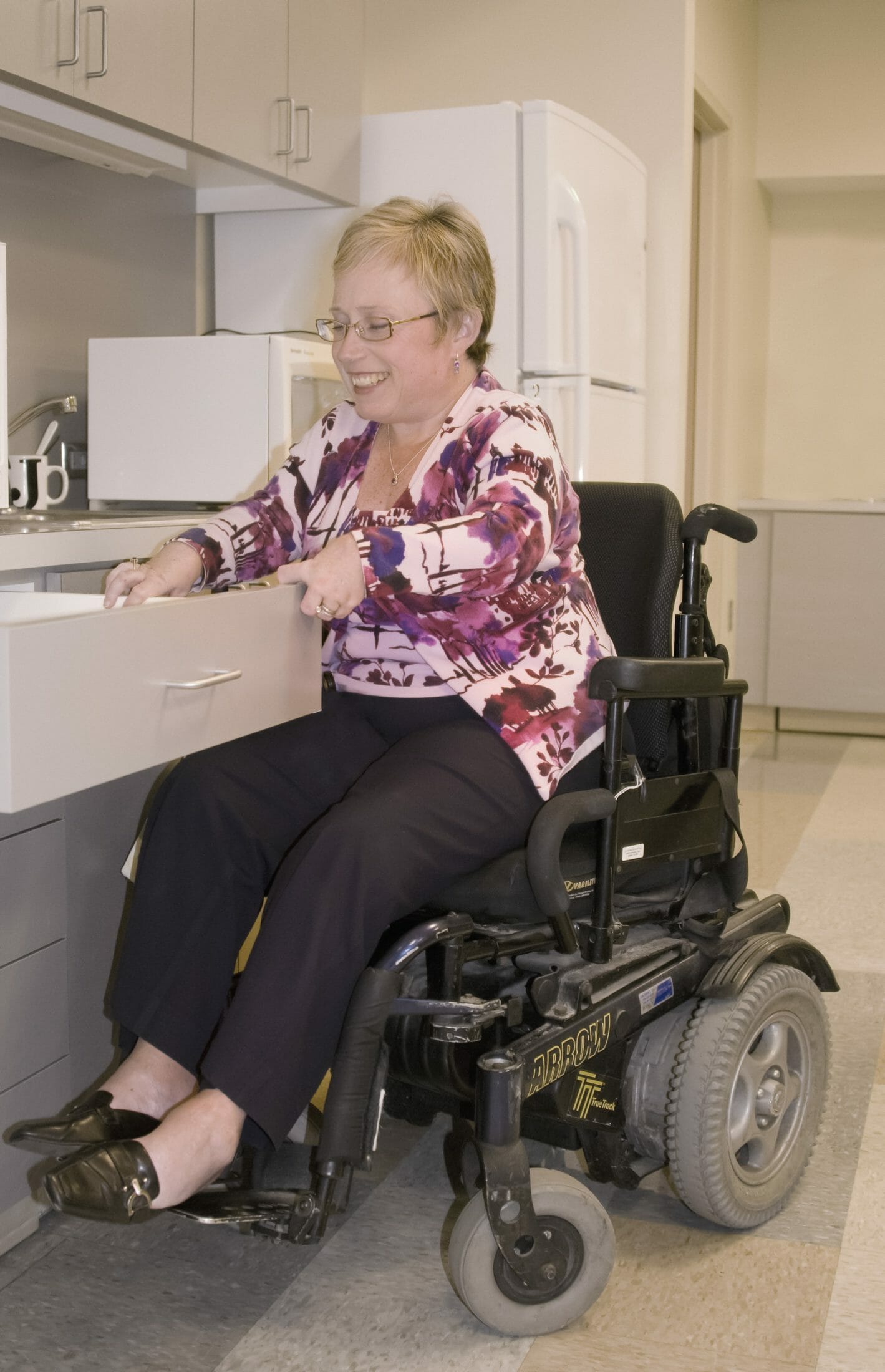 woman in wheelchair looking in drawer